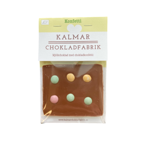 En bild som visar Mini Konfeti- Handgjord och ekologisk minichokladkaka i mjölkchoklad 41% med chokladkonfetti tillverkad av Kalmar Chokladfabrik
