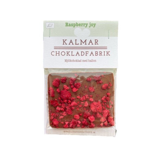 En bild som visar Raspberry joy - Handgjord och ekologisk minichokladkaka i mjölkchoklad 41% med hallon tillverkad av Kalmar Chokladfabrik