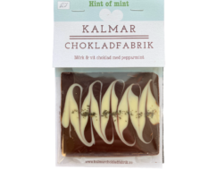 En bild som visar Mini Hint of mint - Handgjord och ekologisk minichokladkaka i mörk choklad 70% och vit choklad 38% med pepparmint tillverkad av Kalmar Chokladfabrik