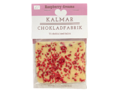 En bild som visar Mini Raspberry dreams - Handgjord och ekologisk minichokladkaka i vit choklad 38 % smaksatt med smulade och sötsyrliga hallon tillverkad av Kalmar Chokladfabrik