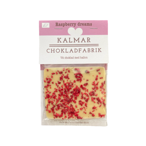 En bild som visar Mini Raspberry dreams - Handgjord och ekologisk minichokladkaka i vit choklad 38 % smaksatt med smulade och sötsyrliga hallon tillverkad av Kalmar Chokladfabrik